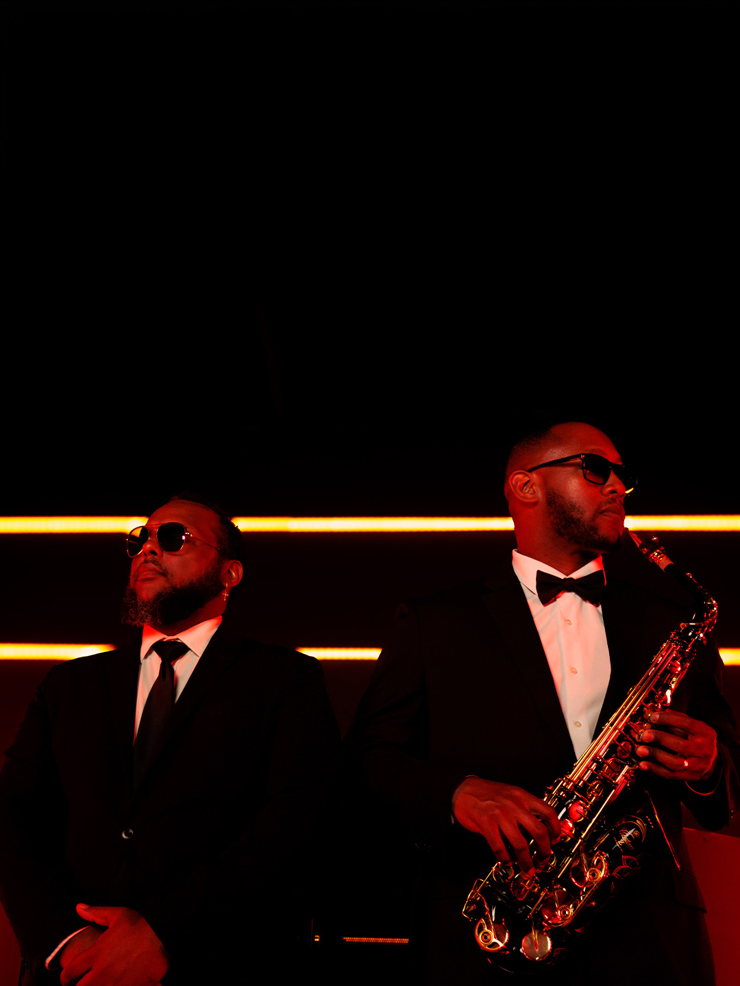 DJ Sir Tim and a saxophonist performing in formalwear