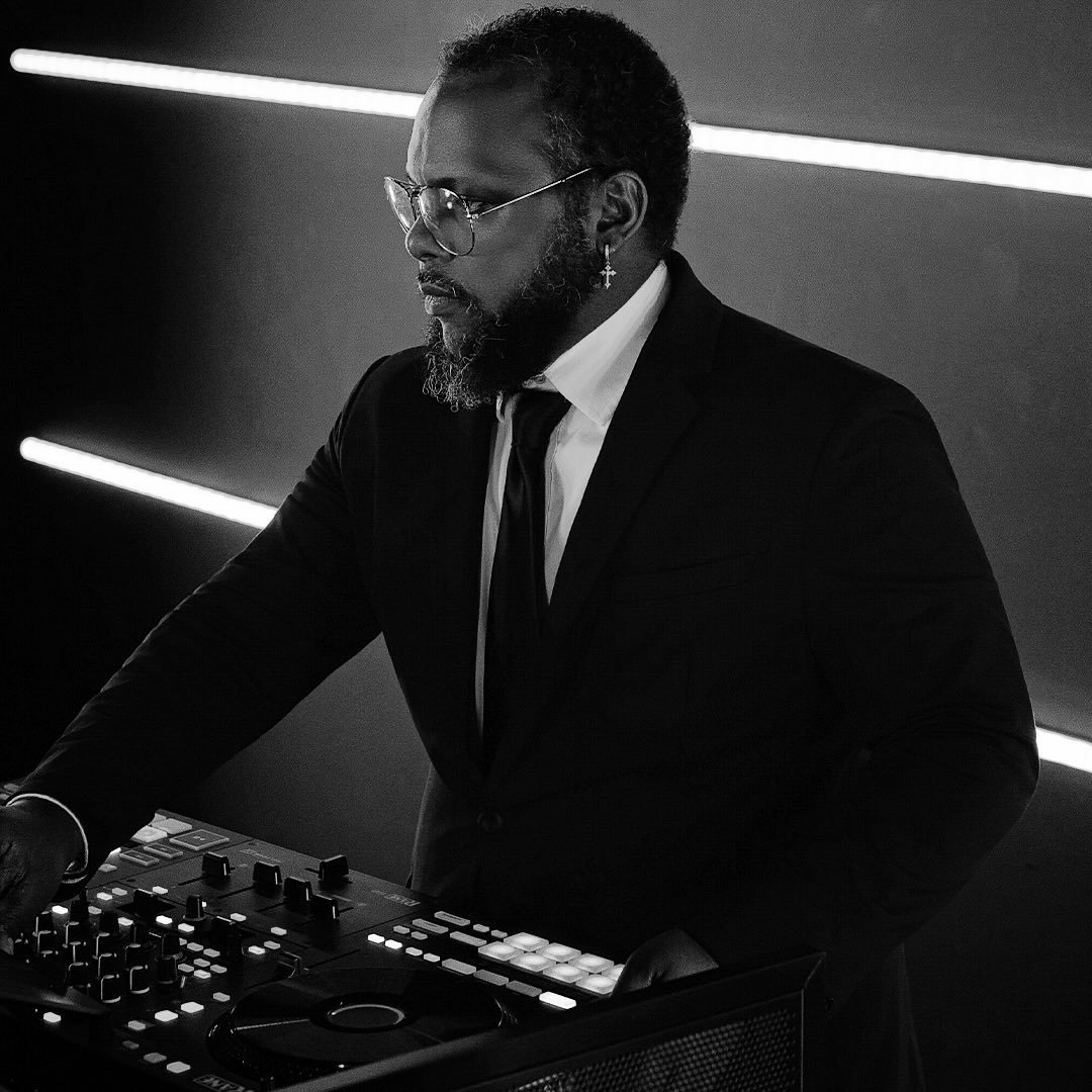DJ Sir Tim performing behind his equipment